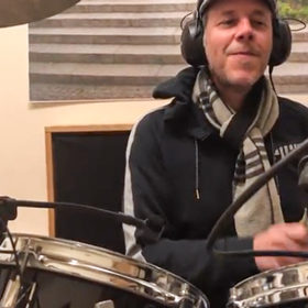 musician plying drums for coronavirus song by project united