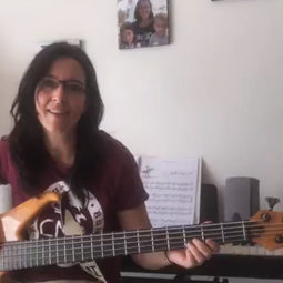 bassist woman recording herself for coronavirus song side by side